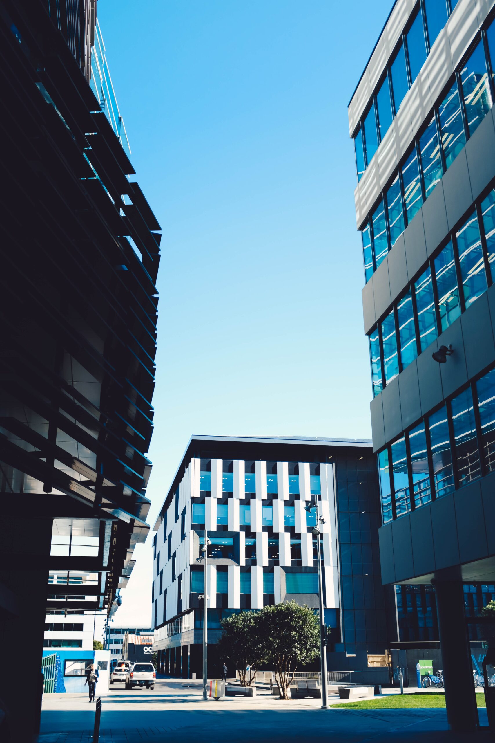 Home Picture Modern Skyscrapers With Blue Windows Parking Area Blue Sky Scaled